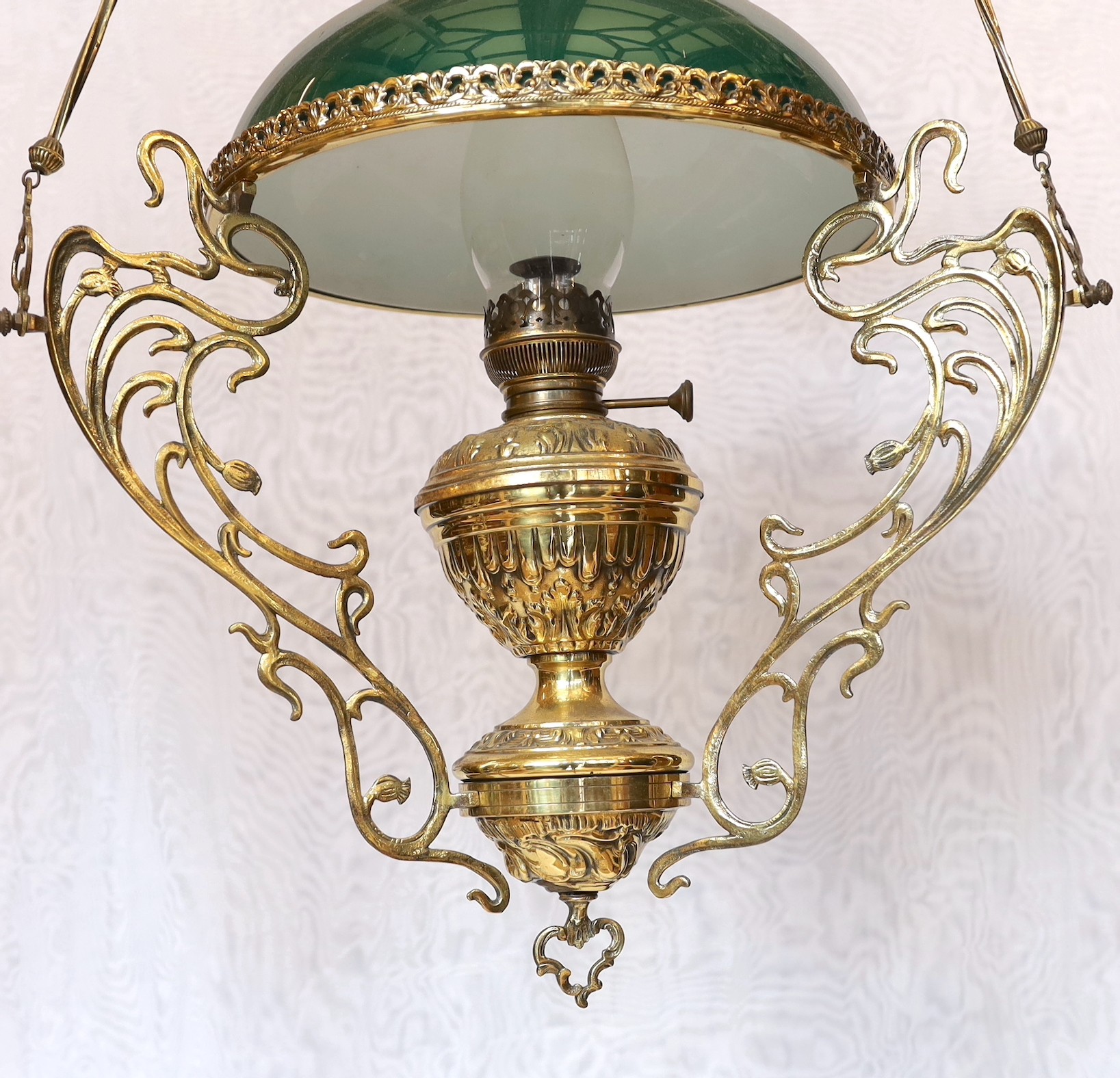 A 19th century French embossed brass counterbalanced hanging oil lamp with opaque glass shade, height 110cm. width 50cm